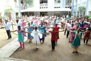 exercise outside as a group men women and children all stretching part of diabetes prevention