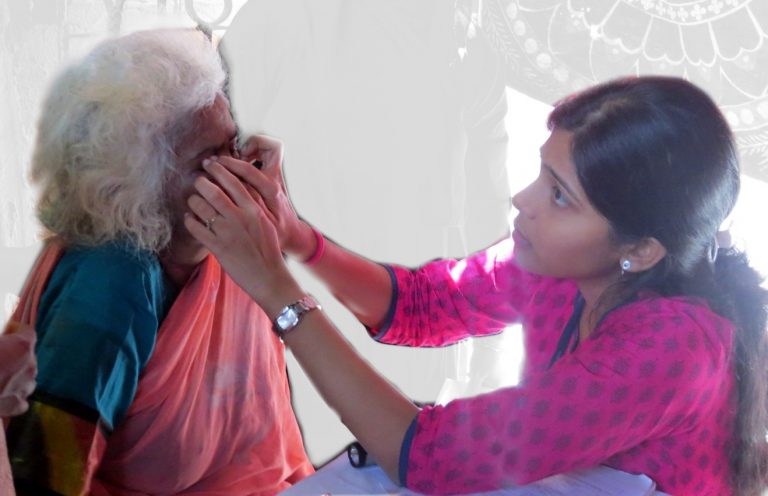 examining an elderly ladies eyes at an eye camp, ophthalmology dept, CMC Vellore